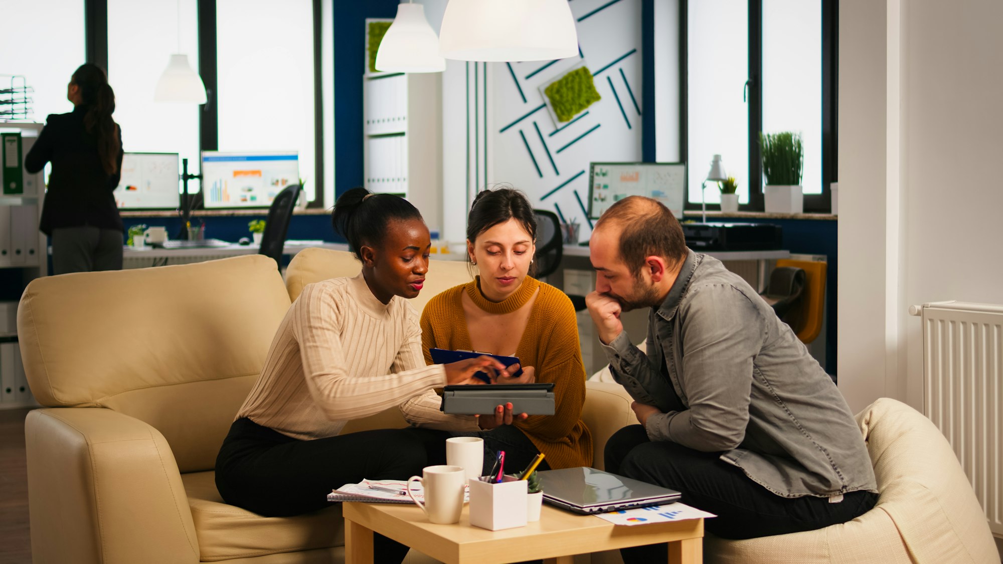 Black Businesswomen shaking hands with manager sitting on couch